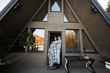 Fototapeta na wymiar Couple in love on terrace off grid tiny house in the mountains.