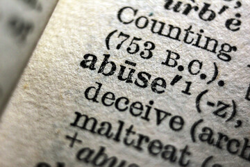 Definition of word abuse on dictionary page, close-up