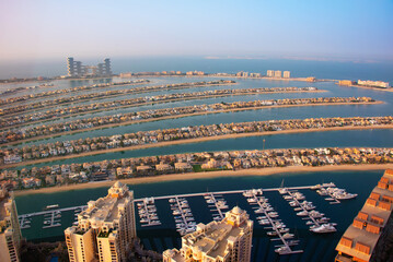 Palm Jumeirah island in Dubai on sunset, modern architecture, beaches and villas