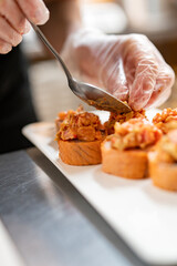 professional chef's hands making sushi roll in a restaurant kitchen