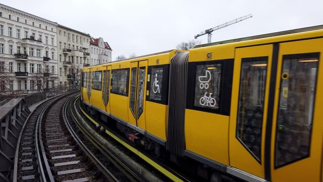 Public Transportations in Berlin with Yellow Color Leaving Train Station
