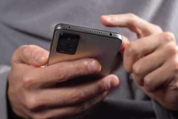 Touch screen smartphone, in hand. Man using smartphone