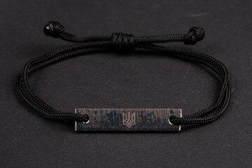 Azovstal limited edition bracelet made of last portion of steel from Azovstal on dark background...