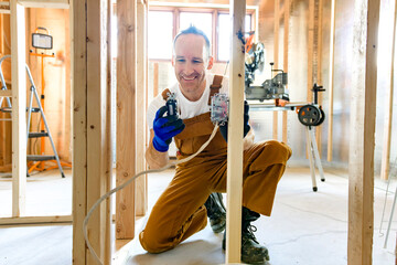 An Electrician Male Working on basement electricity part