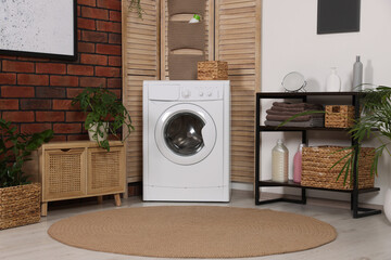 Stylish laundry room with washing machine. Interior design
