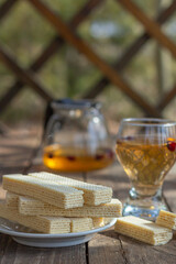 Tea party with sweet Russian waffles on a wooden background. Traditional sweets and dessert.