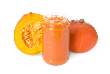 Jar of pumpkin jam and fresh pumpkins on white background