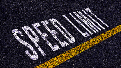 Speed Limit written and yellow line on the road in middle of the asphalt road, Speed Limit word on street.