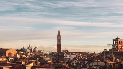 Sundown view of St. Mark's bell tower  and basilica, seen  from Scalinata Contarini del Bovolo.