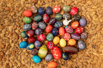 many hand painted colorful easter eggs, according to Sorbian tradition on surface of woven raffia...