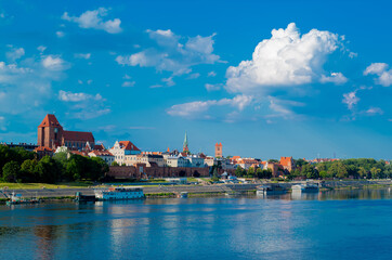 View of Old City of Torun. Vistula (Wisla) river against the backdrop of the historical buildings of the medieval city of Torun. Poland. Europe - obrazy, fototapety, plakaty