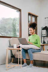 Using laptop pc, Pretty african american girl feeling fatigue lounge at sofa, happy calm lady dream enjoy wellbeing breathing fresh air in summer free time holiday.