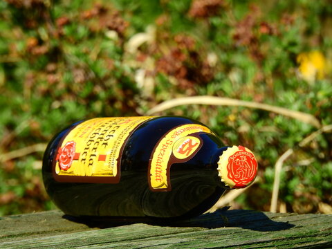 Bottle of Aech Schlenkerla Rauchbeer specialty smoked craft beer on table in early spring garden - Taldom, Russia - May 17, 2019