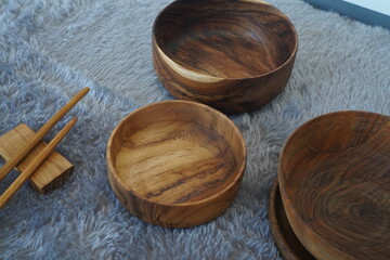 Fototapeta na wymiar Asian wooden bowl, wooden plate, with chopsticks set of wooden tableware.