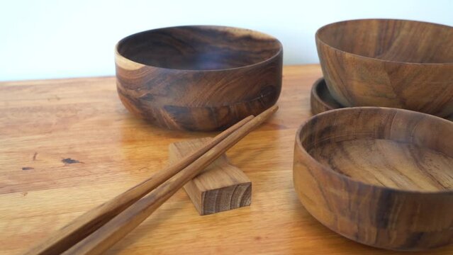 Wooden bowl, chopsticks, ecofriendly concept. set of wooden tableware on wooden table