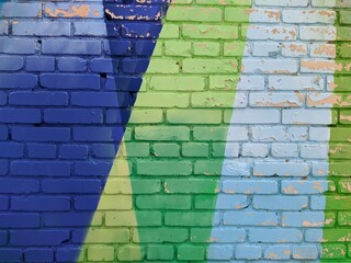 brick wall painted in different bright colors.