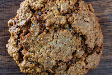 Crust on oat cookies as an abstract background or texture, closeup, top view, macro