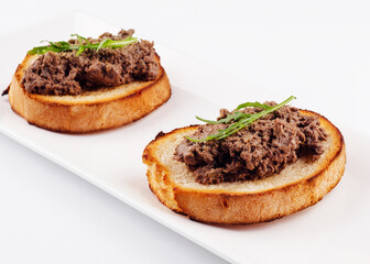 delicious italian bruschetta with truffle pate on white plate