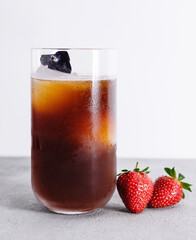 Cold Brew Coffee to Drink with Ice Cubes Decorated with Strawberry