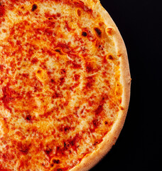 Pizza margarita top view on black