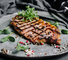 Fried juicy steaks with herbs and spices on plate