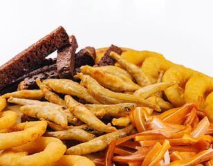 onion rings, fried smelt, pork ears on board