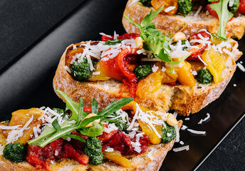 bruschetta with roasted peppers, pesto and parmesan cheese