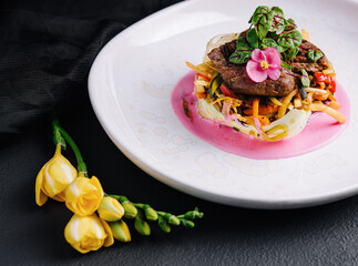 Beef medallions with fresh salad on plate