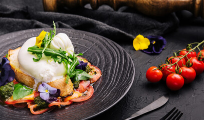 Buffalo burrata cheese served with grain toast pasting and fresh vegetables