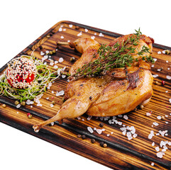 Roasted partridge with sauce tomato on wood board