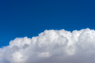 Puffy cumulonimbus cloud with a blue sky