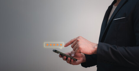 opinion feedback concept, businessman using mobile phone to give evaluation for the good service