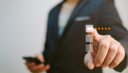 customer satisfaction evaluation concept, businessman hold mobile phone and evaluate for excellent quality of the service so he ranking at five star