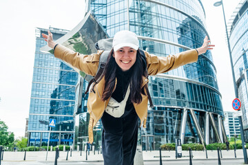 Smiling tourist woman in Warsaw's modern center with skyscrapers