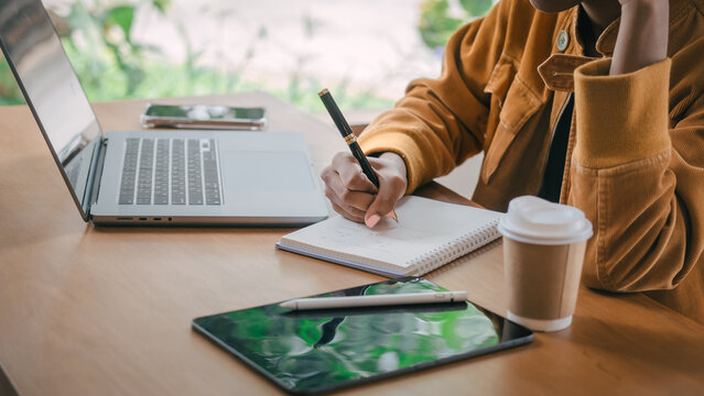 Using pen, Young african american university foreign exchange students study online on laptop pc english language class Virtual Exchange Program by international specialists with master at cafe.