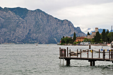 View of Lake Garda with Mountains and Timber Mooring Jetty