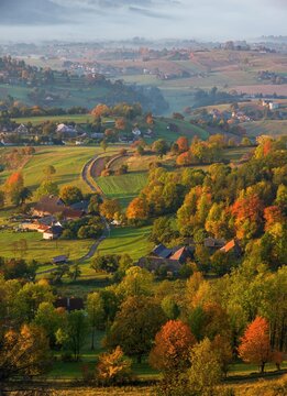 Fall landscape in Slovakia. Rural countryside in Polana region. Fields and meadows with autumn trees in Hrinova at sunrise.