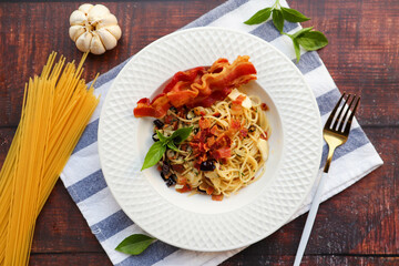 Spaghetti with bacon and dried chili at table top  view - Spaghetti Aglio E Olio