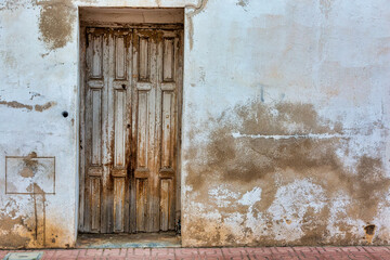 Old Weathered House Wall with Weathered Wood Door: Aged Texture Background