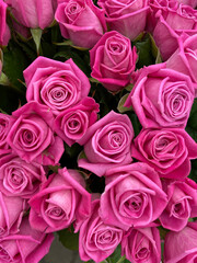 Rose buds in the bouquet are tightly pressed together, rich dark pink shades have a smooth and silky texture.