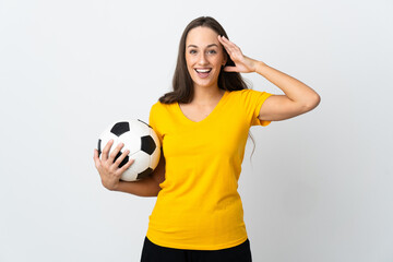 Young football player woman over isolated white background with surprise expression