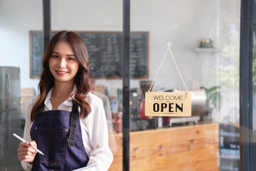 Portrait of a woman, a coffee shop business owner smiling beautifully and opening a coffee shop that is her own business, Small business concept..