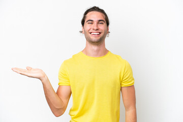 Caucasian handsome man isolated on white background holding copyspace imaginary on the palm to...