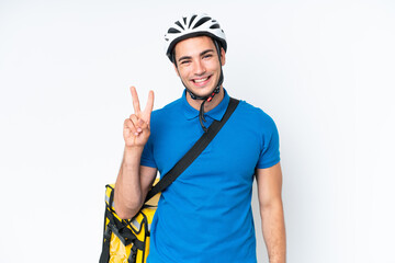 Young caucasian man with thermal backpack isolated on white background smiling and showing victory sign
