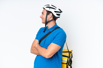 Young caucasian man with thermal backpack isolated on white background in lateral position