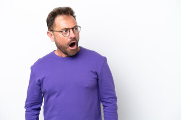 Middle age caucasian man isolated on white background doing surprise gesture while looking to the side