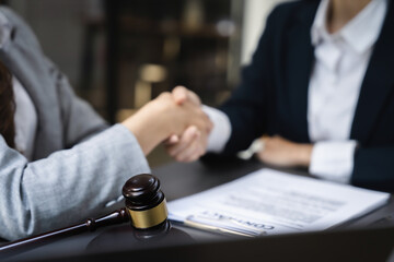 partner lawyers attorneys shaking hands after discussing a contract agreement done.