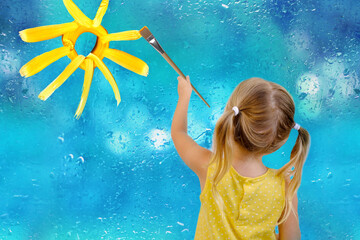 small child, blonde girl 3 years in yellow dress paints with brush multi-colored rainbow, flowers...