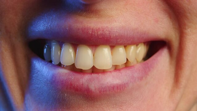 Close-up of a beautiful woman's smile. Clean, white, healthy teeth in a woman's mouth. Close Up of happy woman smiling to camera, showing white smile of after teeth alignment procedure