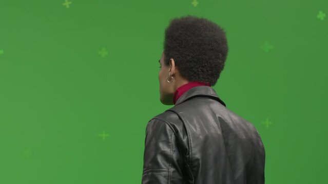 CHROMA KEY Portrait of 20s African-American male student pretending he is visiting art exhibition against green screen